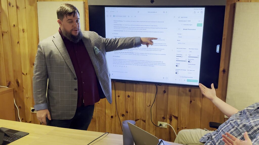 Justin teaching a small group at a screen